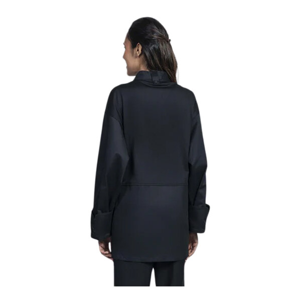 The back view of a person wearing a black Uncommon Chef Pescara chef coat with a black half mesh back.