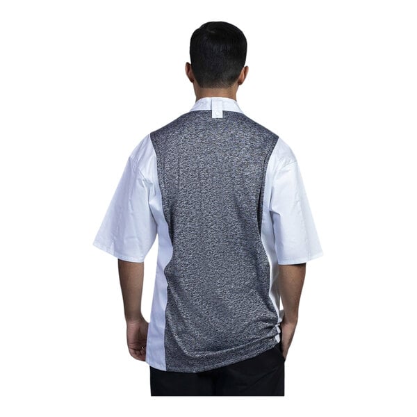 A man wearing a white Uncommon Chef Florence short sleeve chef coat with black mesh.