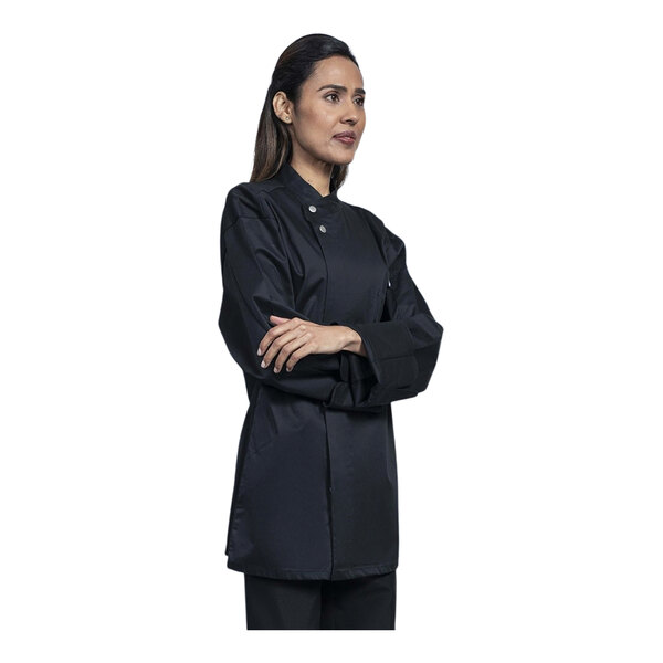 A woman wearing a black Uncommon Chef long sleeve chef coat with a black mesh back.