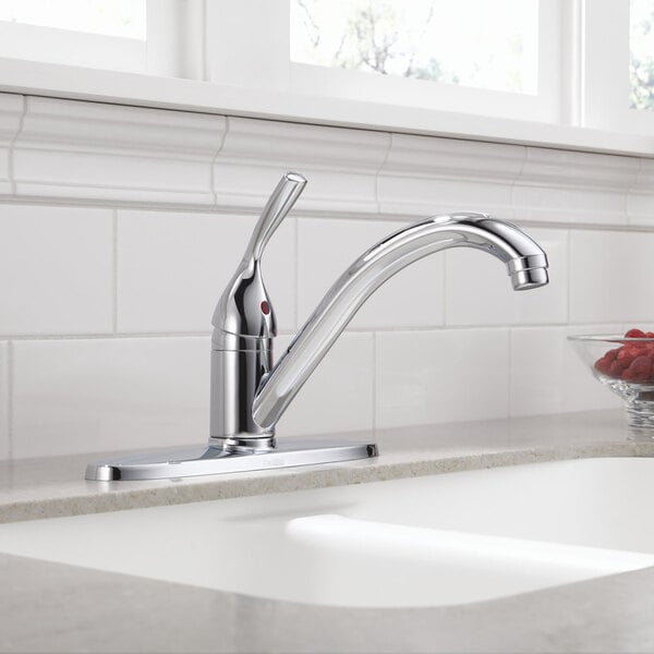 A Delta kitchen faucet with a chrome finish on a countertop.