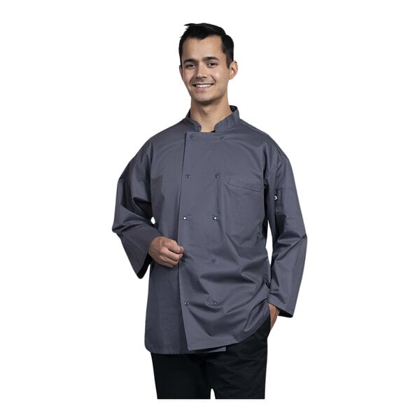 A man wearing a Uncommon Chef slate 3/4 sleeve chef coat with mesh back.