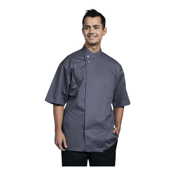 A man wearing a Uncommon Chef slate short sleeve chef coat with slate mesh back.