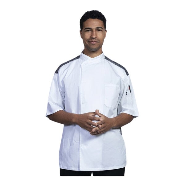 A man wearing a white Uncommon Chef Modena chef coat with black accents.