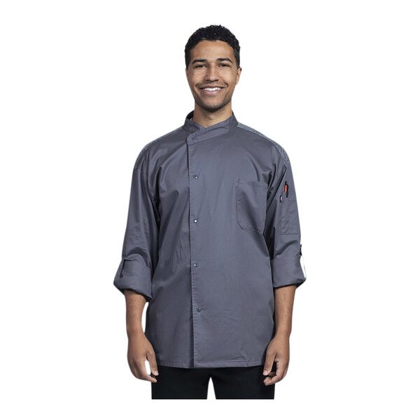 A man wearing a Uncommon Chef Roma long sleeve chef coat with gray mesh back.