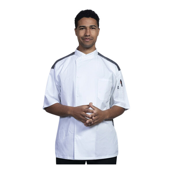 A man wearing a white Uncommon Chef short sleeve chef coat with black mesh back.