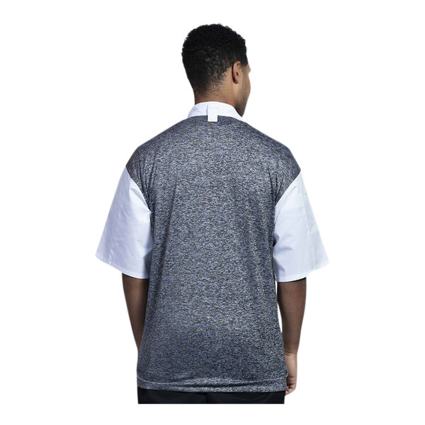 A man wearing a white Uncommon Chef Modena chef coat with a black and grey mesh back.