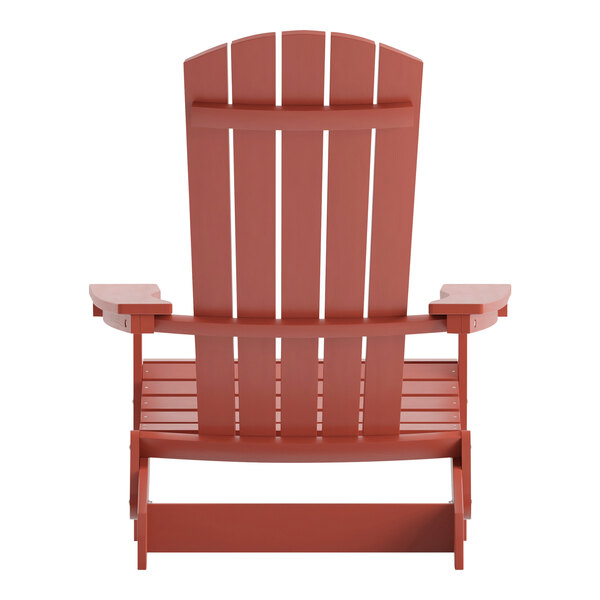 A close-up of a red wooden Flash Furniture Charlestown folding Adirondack chair with armrests.