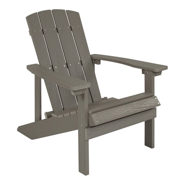 A gray wooden Adirondack chair with armrests.