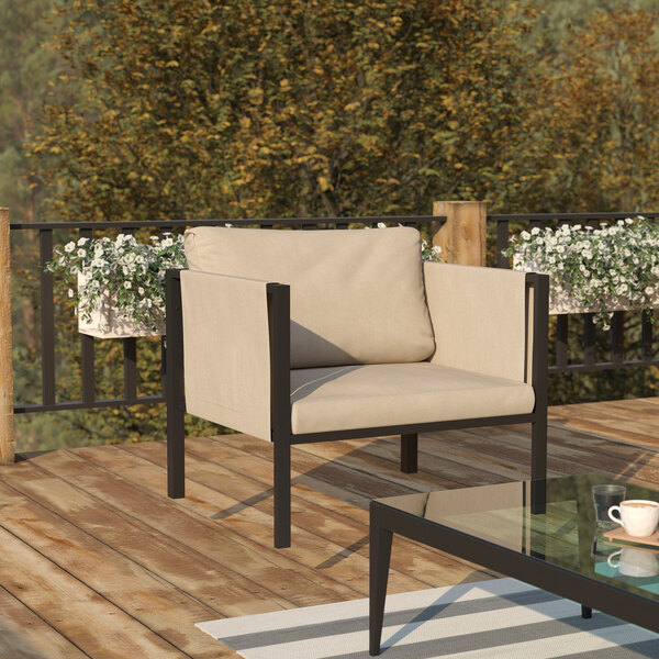 A Flash Furniture Lea black steel frame arm chair with beige cushions and storage pockets on a deck.