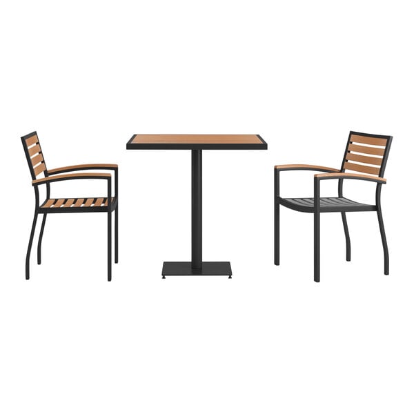 A Flash Furniture outdoor table with a black base and natural faux teak slat top with two stackable arm chairs.