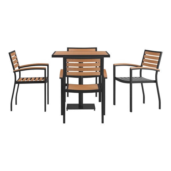 A Flash Furniture outdoor dining set with a natural faux teak table and black stackable arm chairs with wood slat seats.