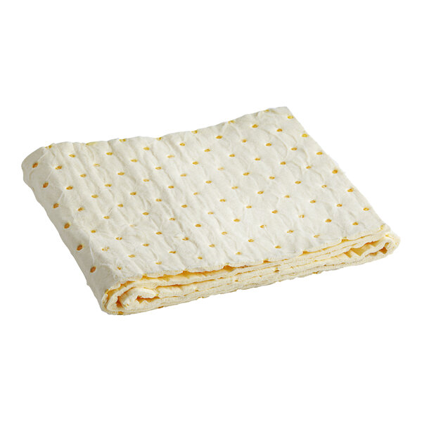 A folded white wicking pad with yellow dots.