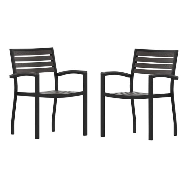 A pair of black Flash Furniture outdoor arm chairs with a white background.