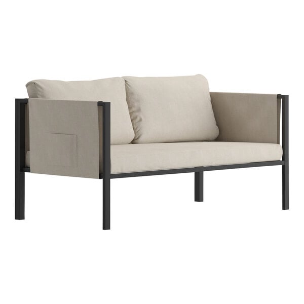 A white Flash Furniture loveseat with black legs and beige cushions on a white surface.