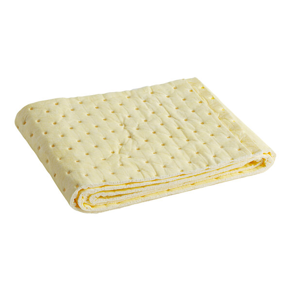 A folded yellow wicking pad with dots on it.