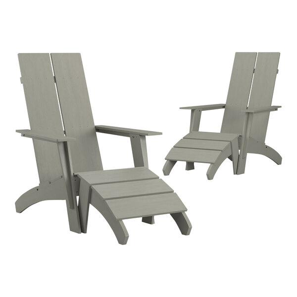 A pair of grey Adirondack chairs with a footrest.