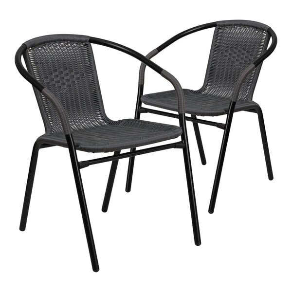 A pair of black Flash Furniture rattan arm chairs.