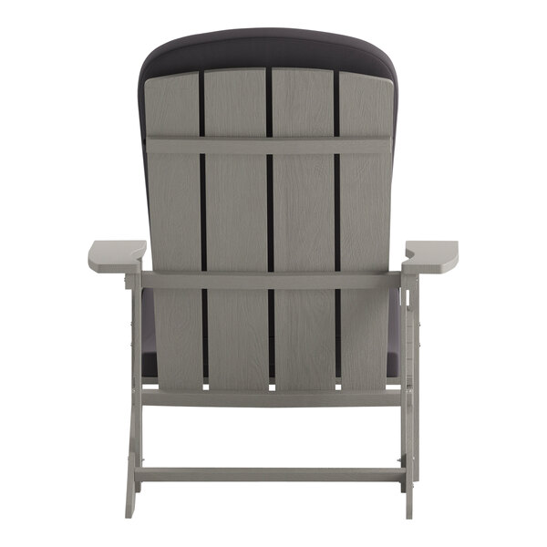 The back of a light gray Flash Furniture faux wood Adirondack chair with gray cushions.