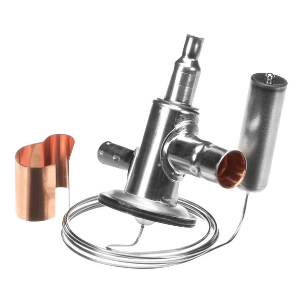 A close-up of a Manitowoc Ice expansion valve kit with a copper tube and metal device.