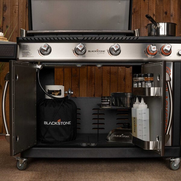 A Blackstone outdoor griddle with a pan and pot on it.