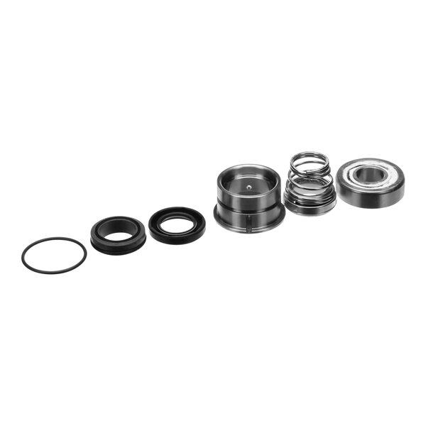A Manitowoc Ice evaporator rebuild kit on a table with a group of metal objects.