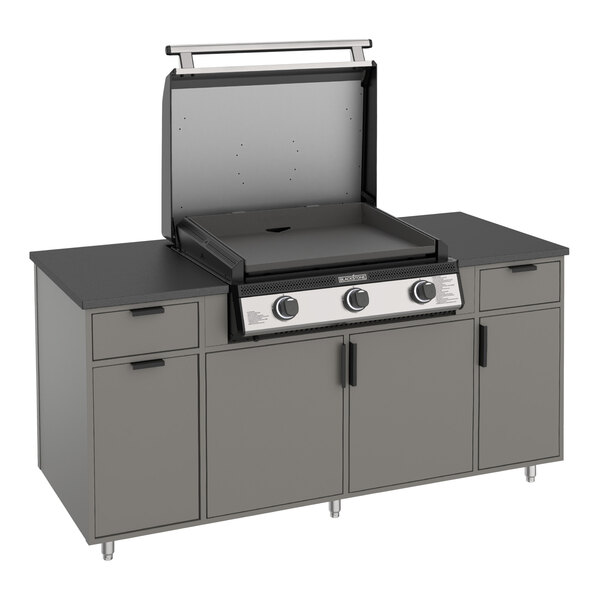 A Blackstone outdoor griddle with a stainless steel top on an outdoor counter.