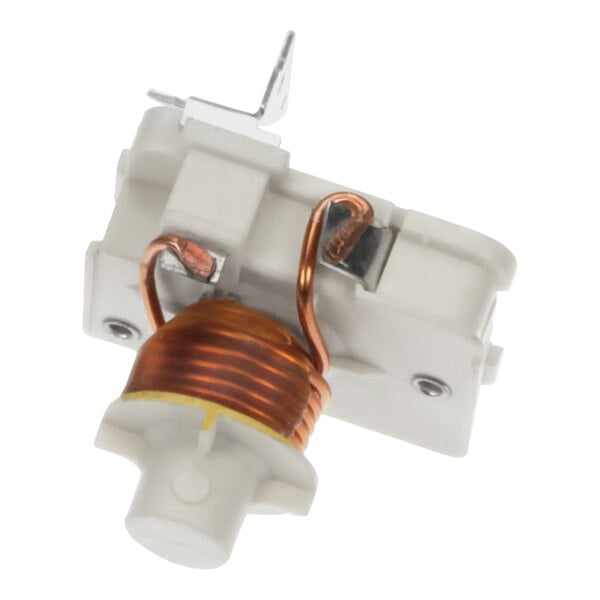 A close-up of a white Manitowoc Ice starter device with copper coils.