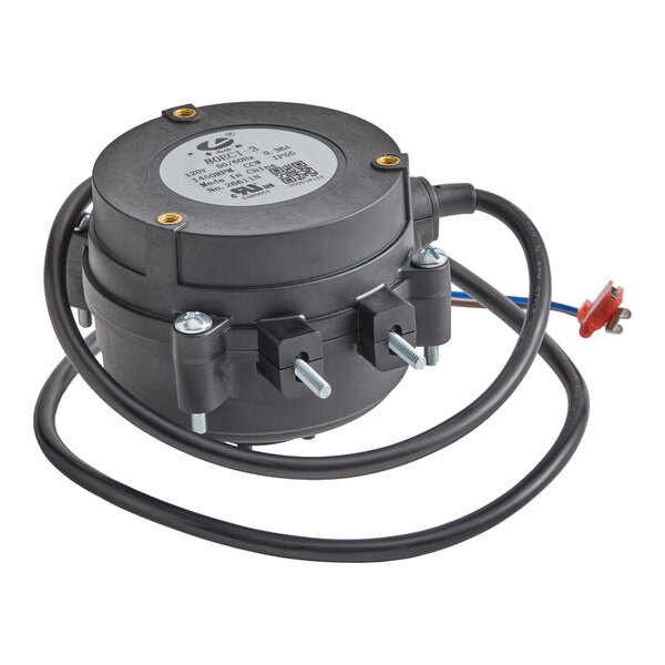 A black cylindrical device with attached wires and mounting bolts, likely an electric motor component.