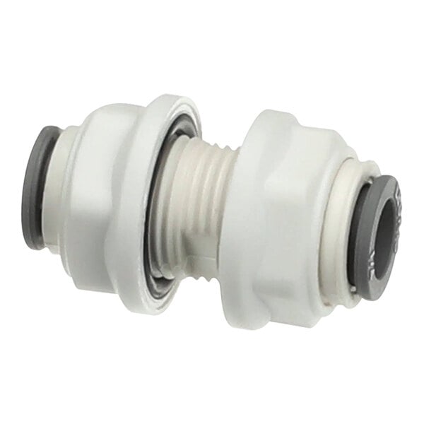 A white plastic pipe fitting with two black nuts and a grey rubber connector.