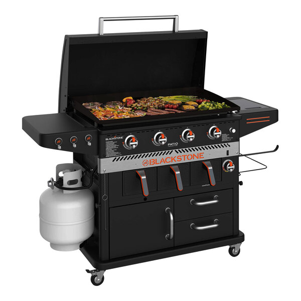 A Blackstone outdoor griddle with a large cooking area and propane tanks.