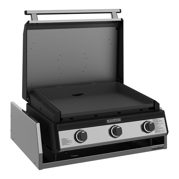 A Black and silver Blackstone outdoor kitchen griddle with a lid.