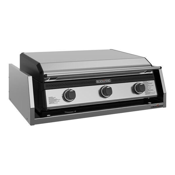 A Blackstone outdoor kitchen griddle with a black top and knobs.