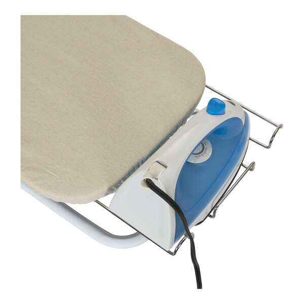 A Household Essentials tabletop wood ironing board with a natural cover and iron rest on a table.