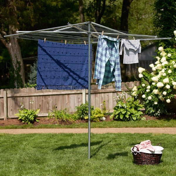 A Household Essentials outdoor clothesline with clothes hanging on it.