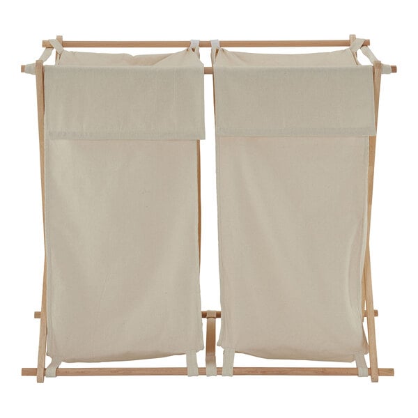 A Household Essentials laundry sorter with two white bags hanging on a wooden X-frame.