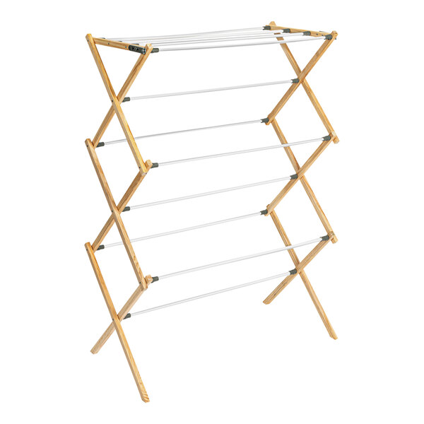 A wood X-frame drying rack with white metal rods.