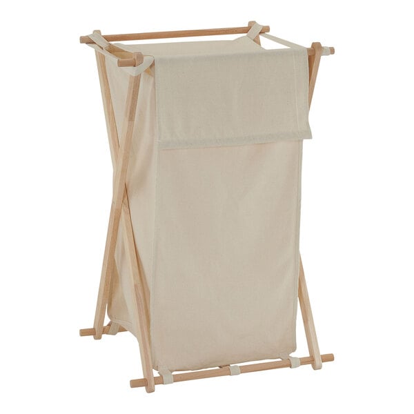 A white cloth laundry basket on a wooden stand.