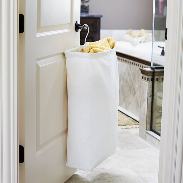 A white bag hanging from a door.