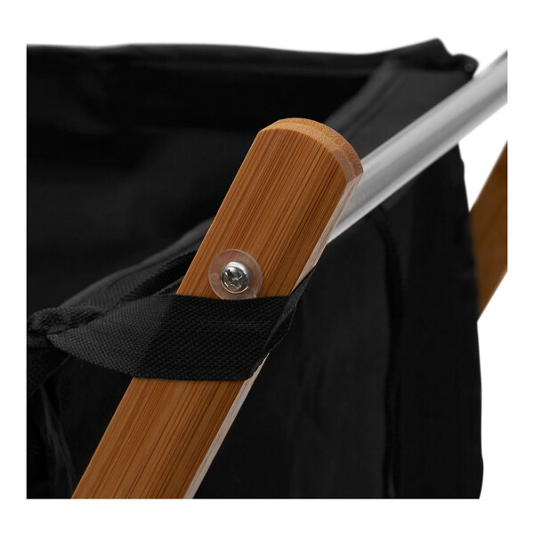 A black laundry bag on a bamboo X-frame.