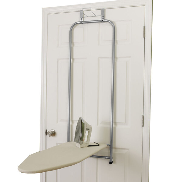 A white Household Essentials ironing board hanging on a door.