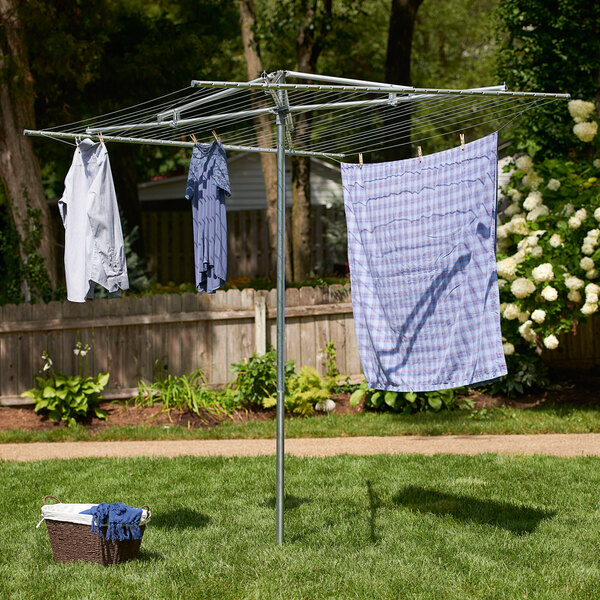 A Household Essentials steel rotary clothes line with clothes hanging on it.