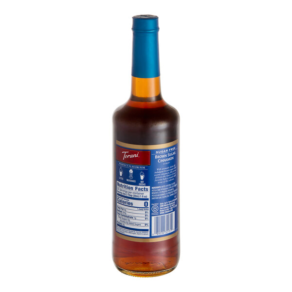 A close up of a Torani Sugar-Free Brown Sugar Cinnamon Flavoring Syrup glass bottle with a blue label.