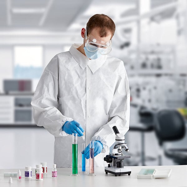 A man wearing a Lavex white microporous lab coat and goggles.
