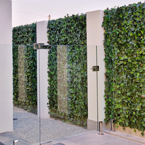 A wall covered with NatraHedge artificial ivy panels.