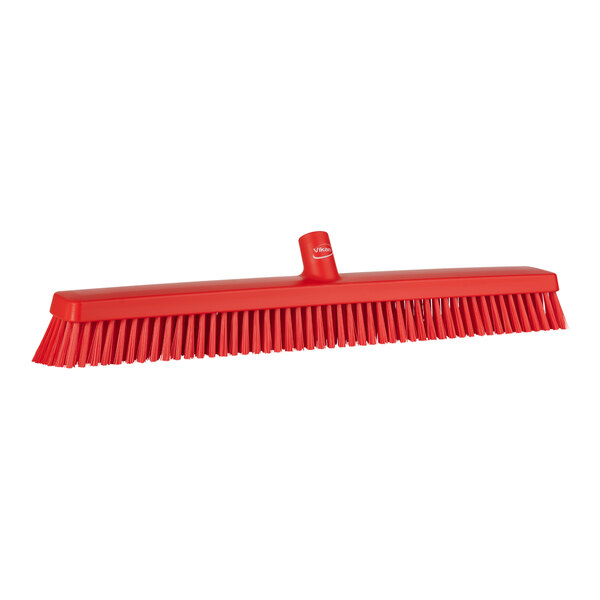 A Vikan red heavy-duty push broom head with soft / stiff bristles.