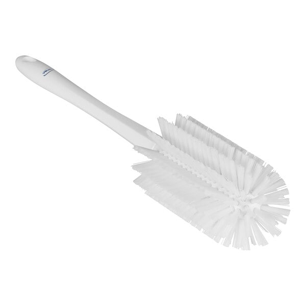 A white brush with bristles and a handle.