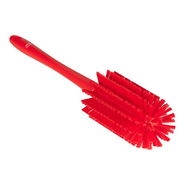 A red Vikan pipe brush with a handle and bristles.