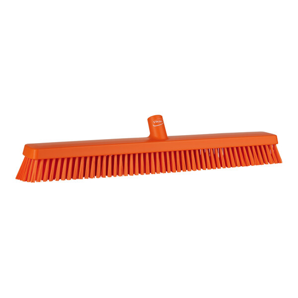 An orange Vikan heavy-duty push broom head with soft and stiff bristles.