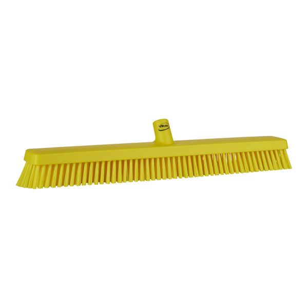 A yellow Vikan heavy-duty push broom head with soft/stiff bristles.