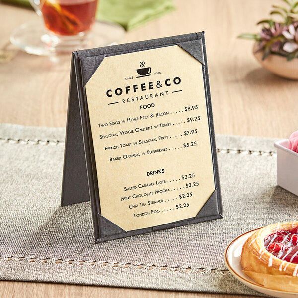 A Choice gold menu on a table next to a plate of pastries.